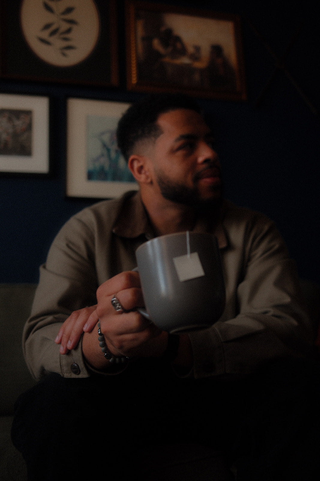 Man holding a cup of Doze Tea as part of a nighttime wind-down routine