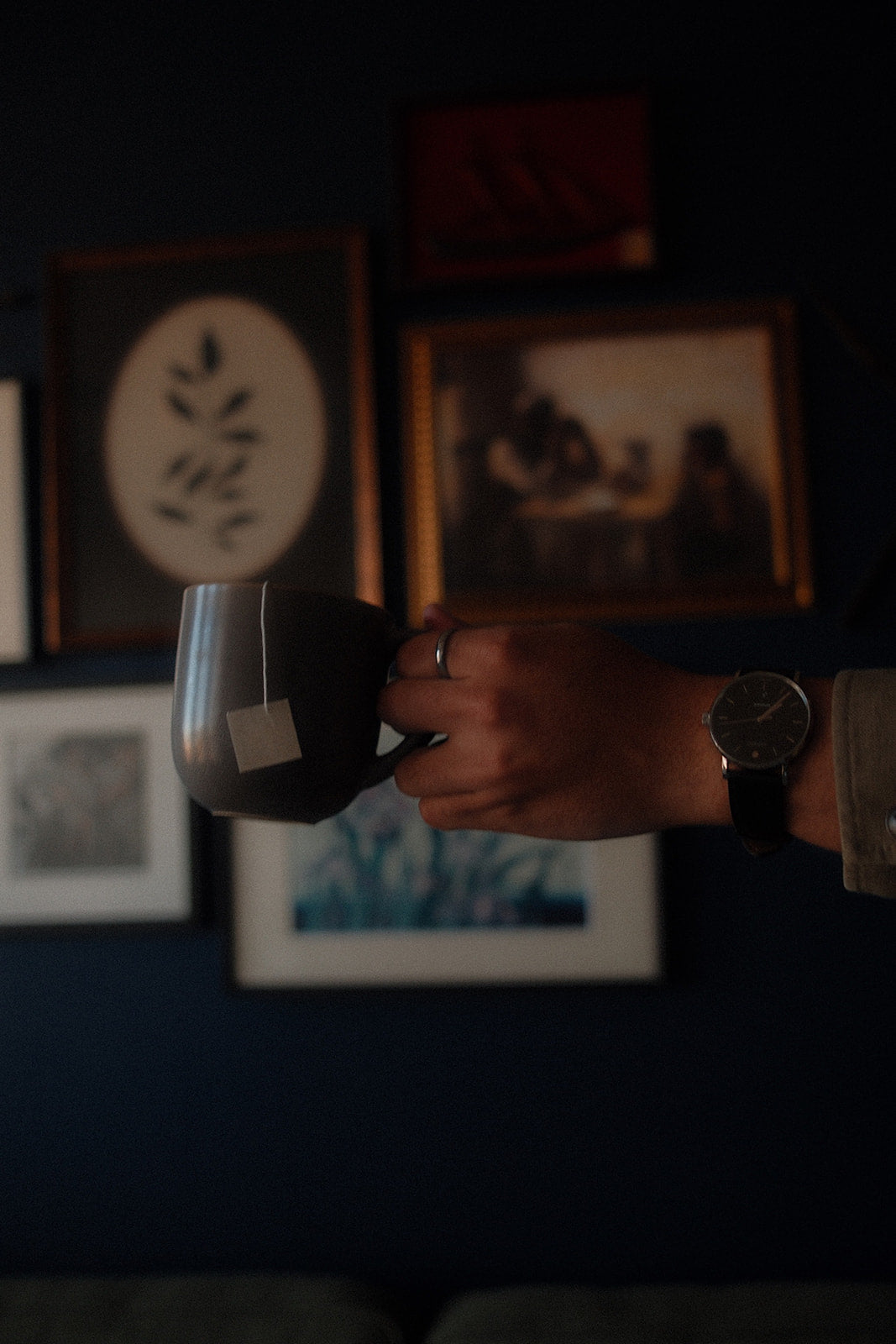 Man holding a cup of Doze Tea as part of a nighttime wind-down routine